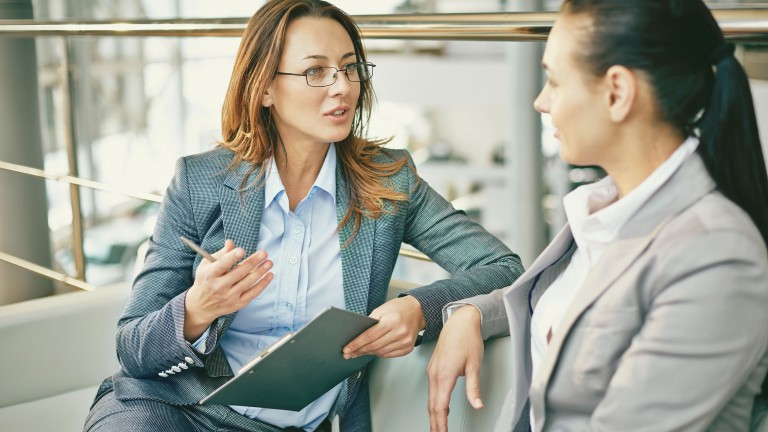 two-businesswomen-talking-outside