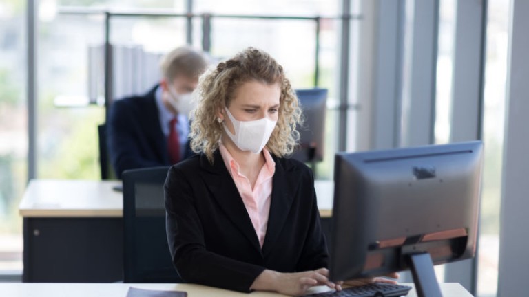 Women in office wearing mask