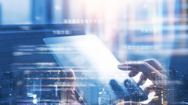 Hands typing on a tablet