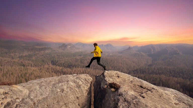 Man jumping over rocks
