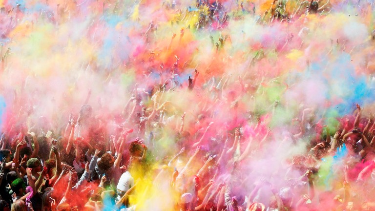 People throwing coloured powder during the Holi festival in Barcelona