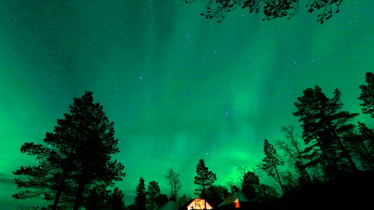 An Aurora Borealis (Northern Lights) is seen over a mountain camp north of the Arctic Circle, near the village of Mestervik