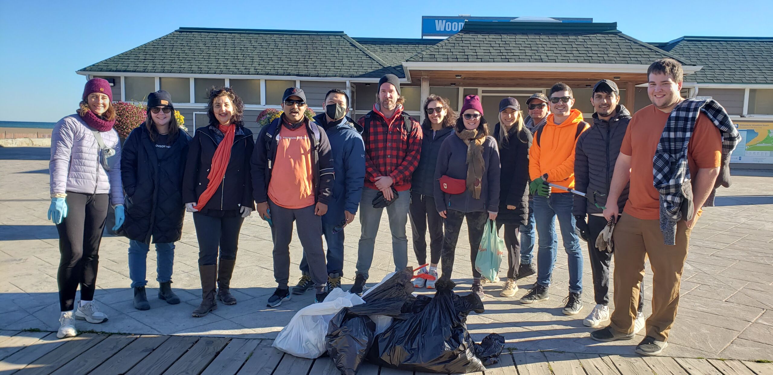 Thomson Reuters teammates in Toronto pose for a group photo while cleaning up a local beach during global volunteer day.