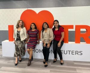 Four teammates posing for a group photo in front of the I love Thomson Reuters sign in our Bangalore office.