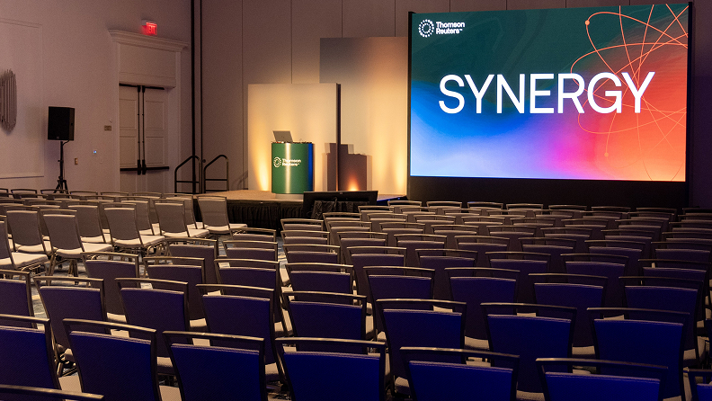 Empty theater with Synergy logo displayed on screen